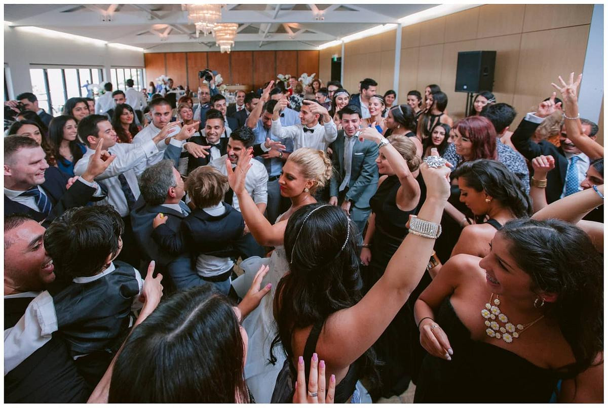 Bridal party celebrating with laughter and cheers on the dance floor at Sergeants Mess Mosman.