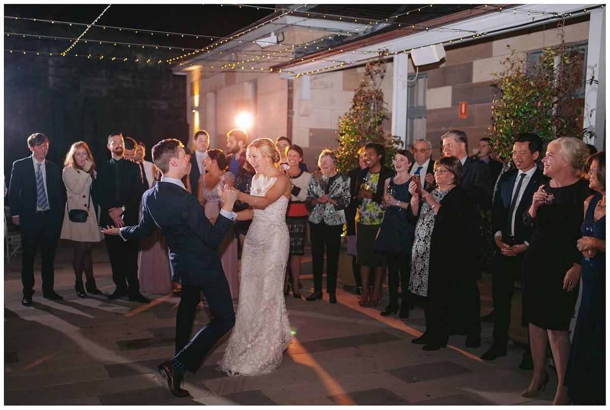 Bride and groom sharing their first dance, surrounded by guests at Gunners Barracks Mosman.