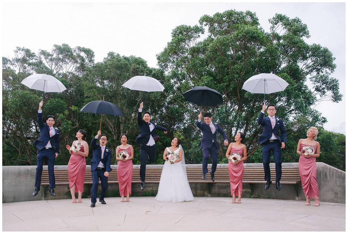 Bridal party celebrating with laughter and cheers in a lively wedding photo at Georges Head Lookout, Gunners Barracks Mosman.